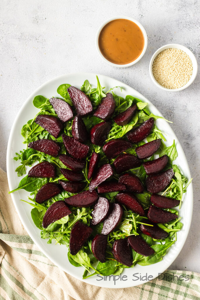 Beets laid out on a bed of arugula.