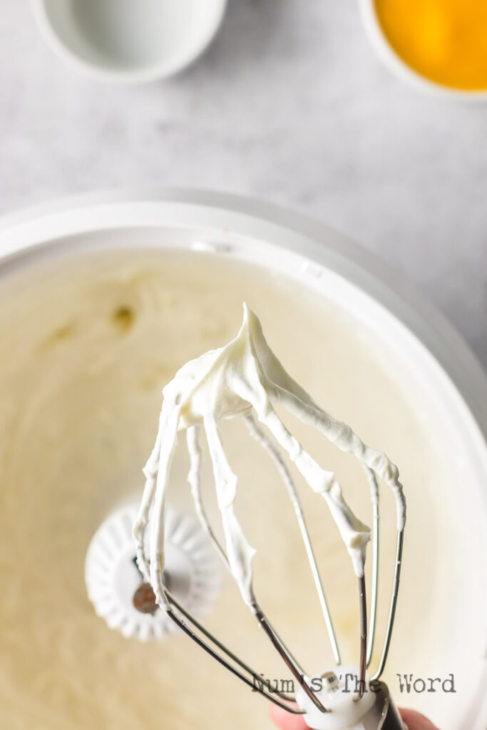 Whipped cream with soft peaks.