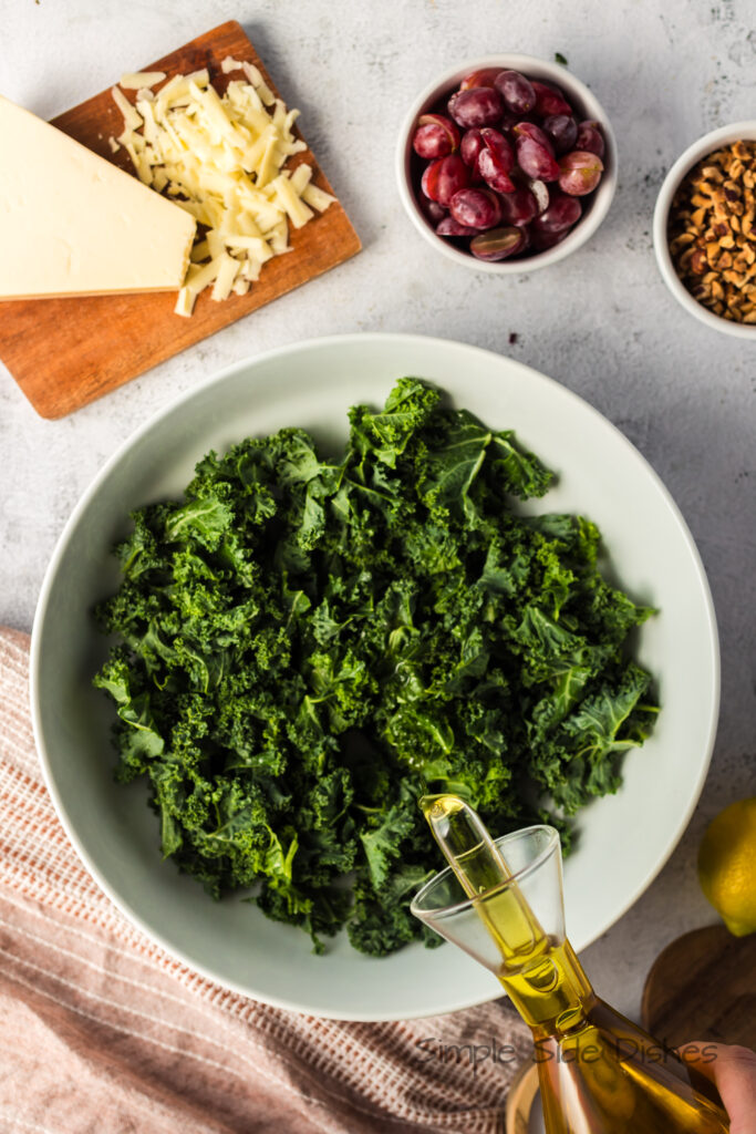 olive oil being drizzled on to kale