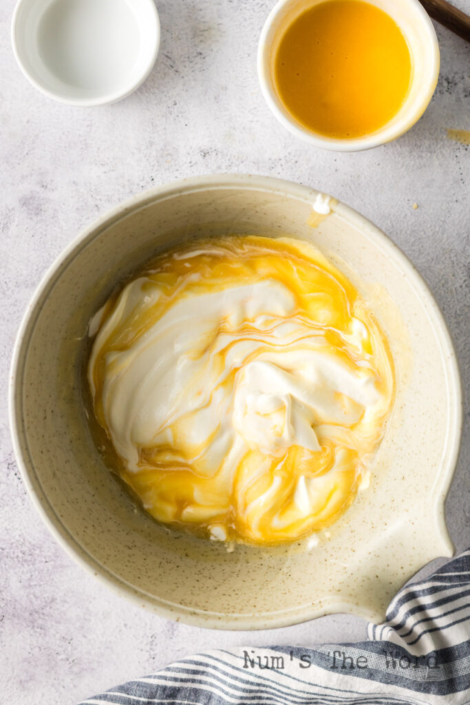 Peaches folded into whipped cream in the bowl.